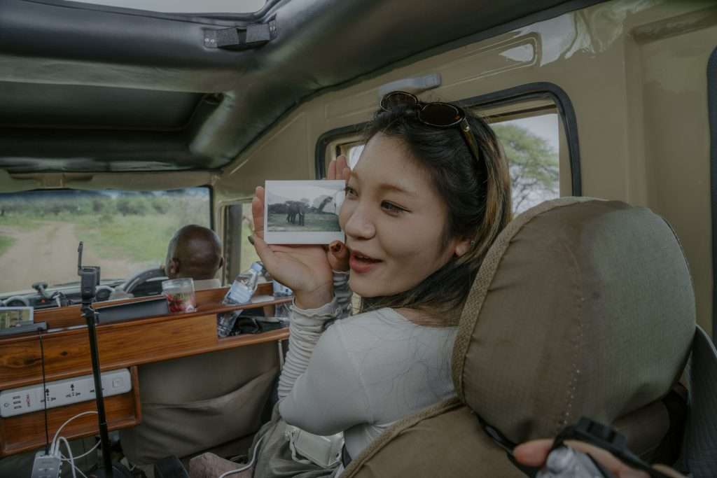 Luxury Tanzania safari game drive in Serengeti with tourists enjoying wildlife experience