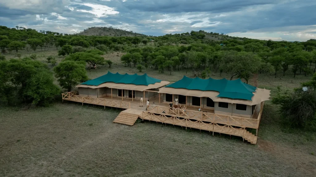 Aerial view of two luxury honeymoon tented suites on elevated wooden decks at Signature Serengeti Safari Camp in Tanzania.