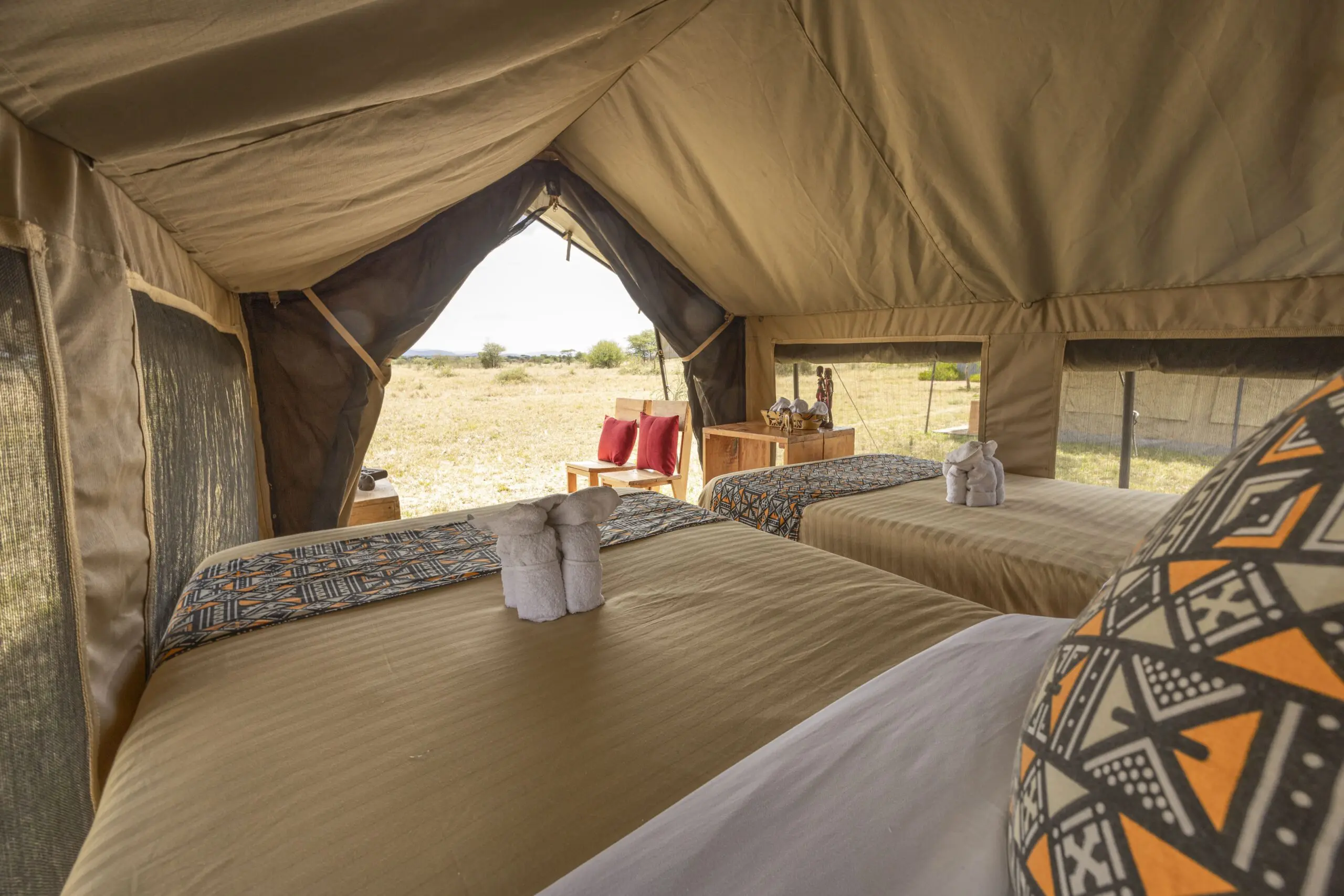 Safari Comfort Room at Africa Safari Serengeti Ikoma featuring a king-size bed, private balcony, and stunning Serengeti views