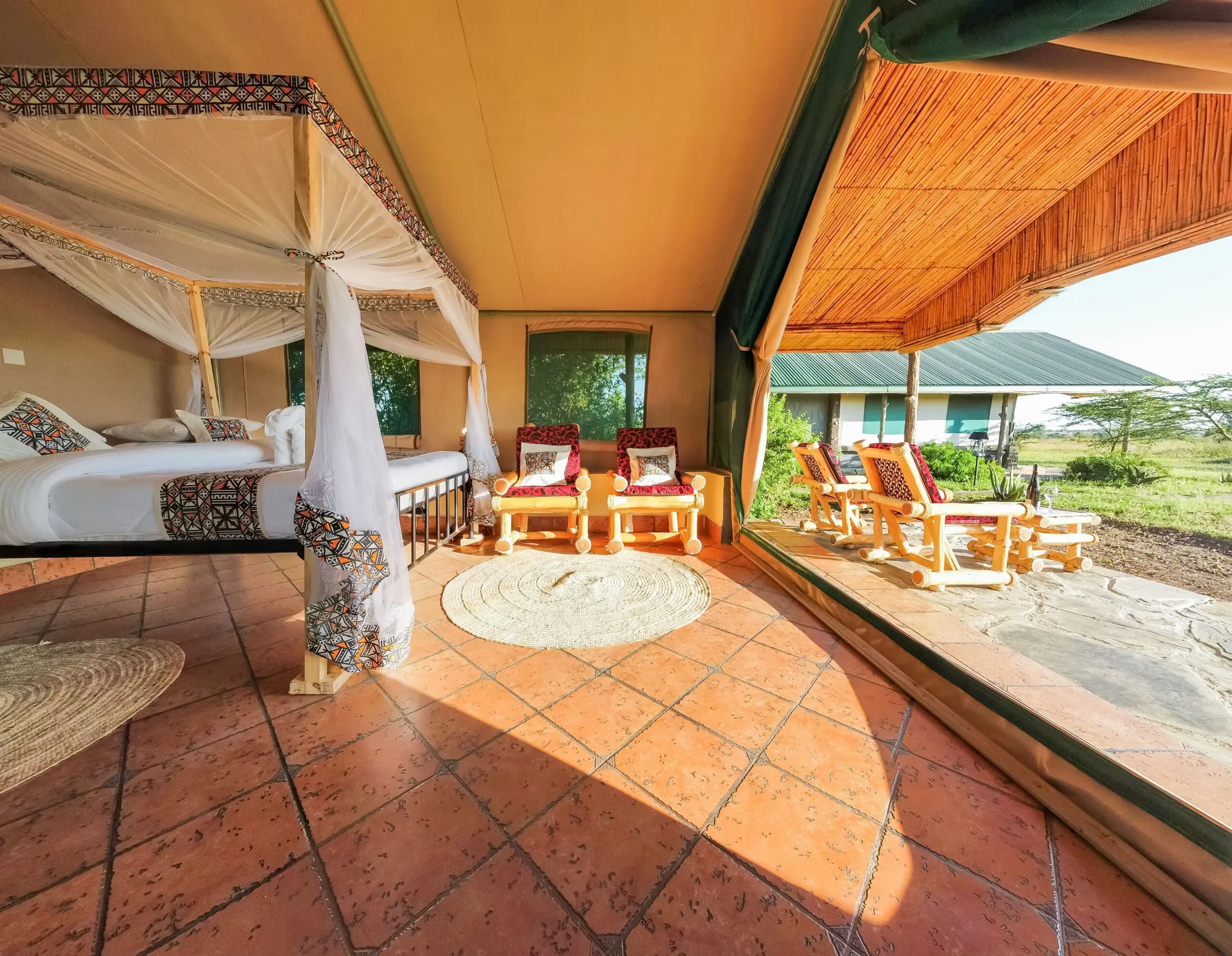 Safari Comfort Room at Africa Safari Serengeti Ikoma featuring a king-size bed, private balcony, and stunning Serengeti views