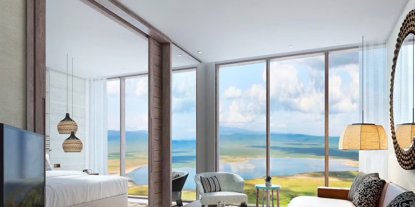 Crater View Suite at Meliá Ngorongoro Lodge with floor-to-ceiling windows overlooking Ngorongoro Crater.