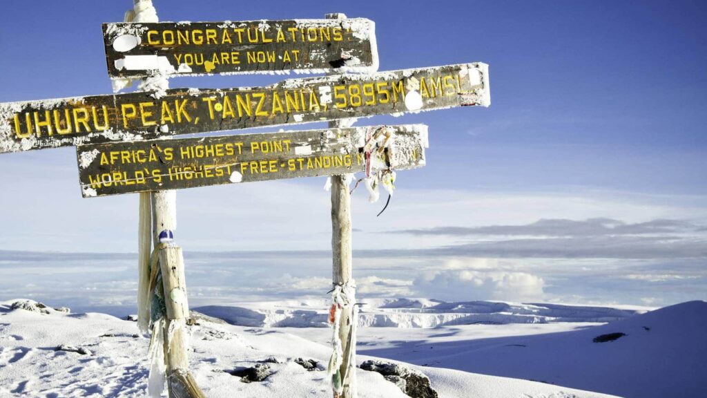Hiker following a Kilimanjaro Training Guide while climbing Mount Kilimanjaro