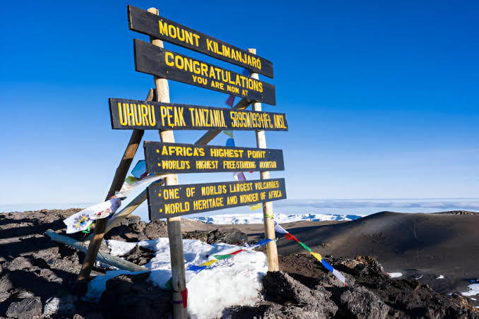 Why Are Kilimanjaro Climbs Expensive showing guides and porters on Mount Kilimanjaro